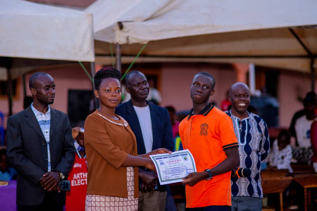 A student receiving a certificate for Music, Dance and Drama