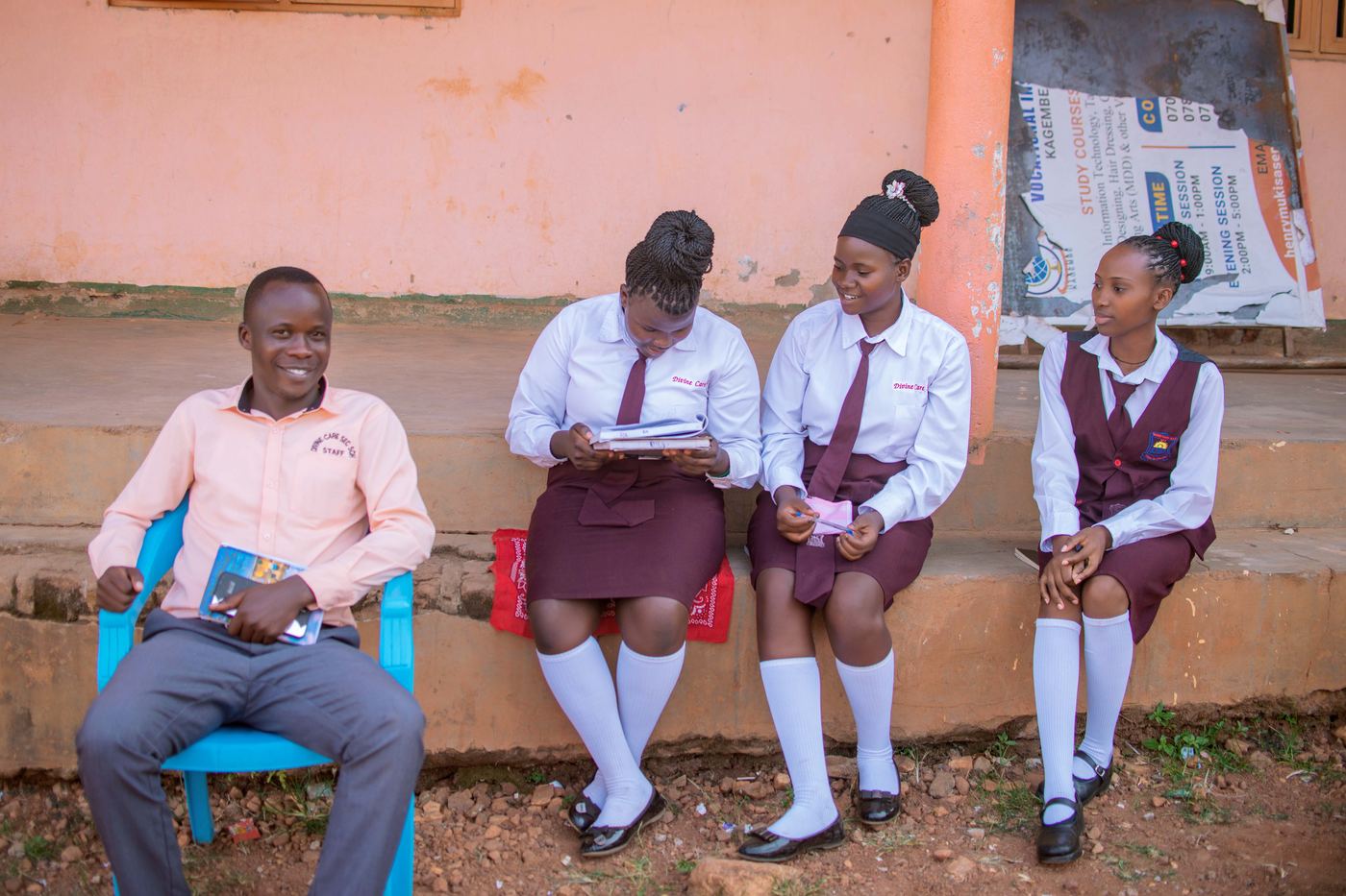 Students reading together with a teacher outside the library