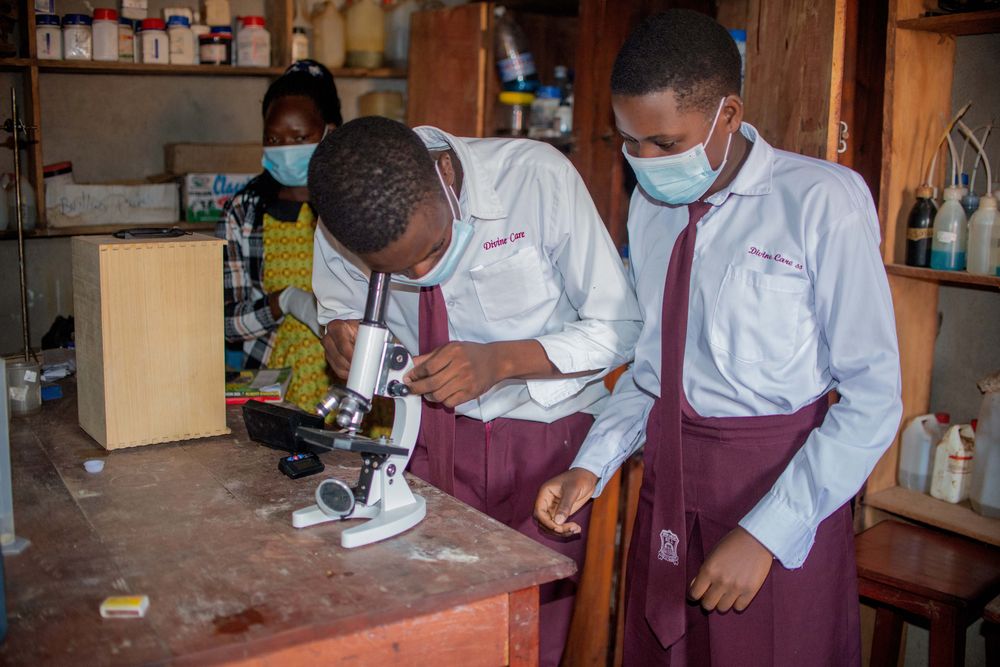 Students examining a specimen under a microscope in the science lab